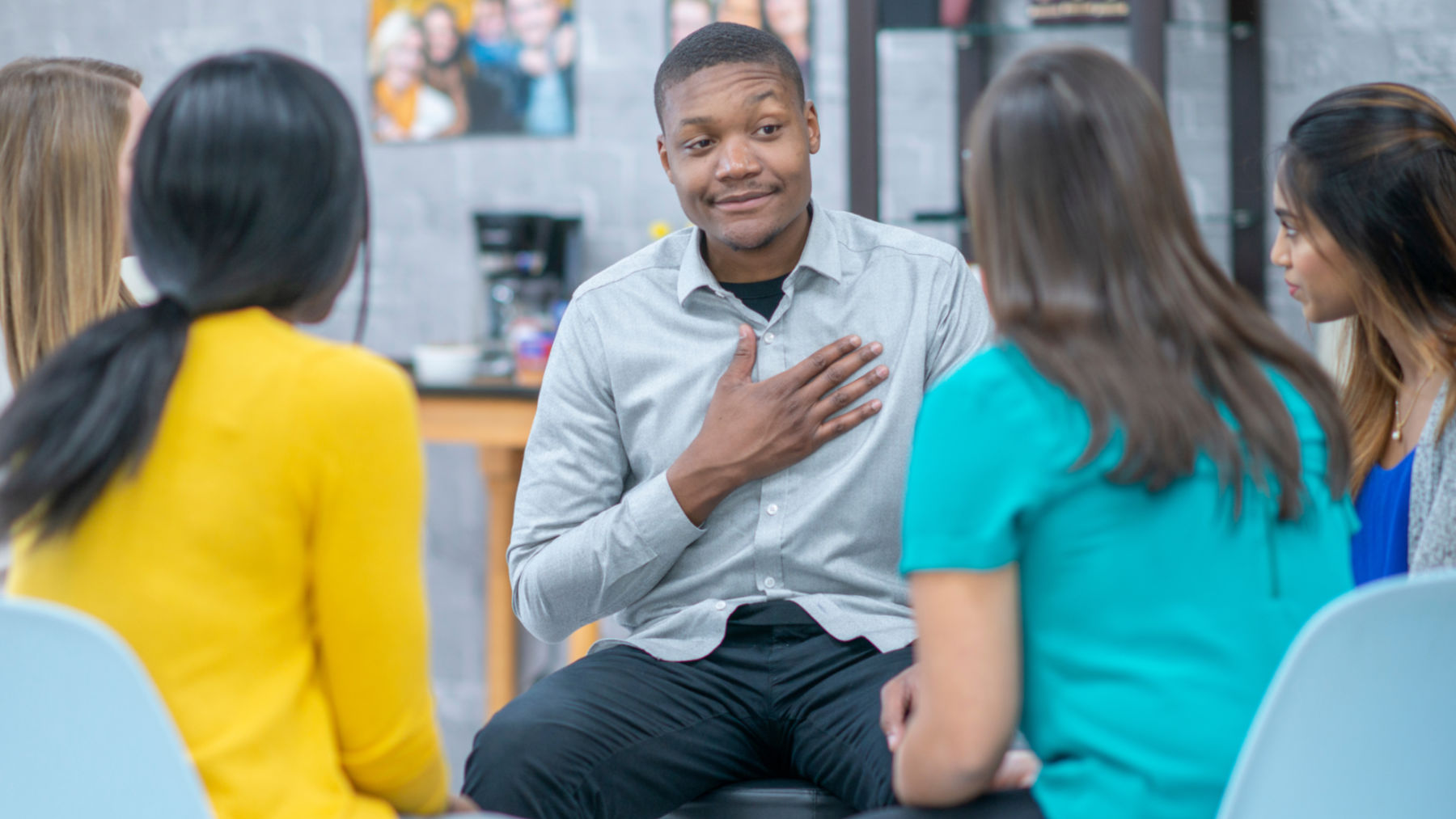 Man smiling in group therapy